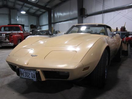 A beige Corvette we restored, sitting in our wheel alignment building.